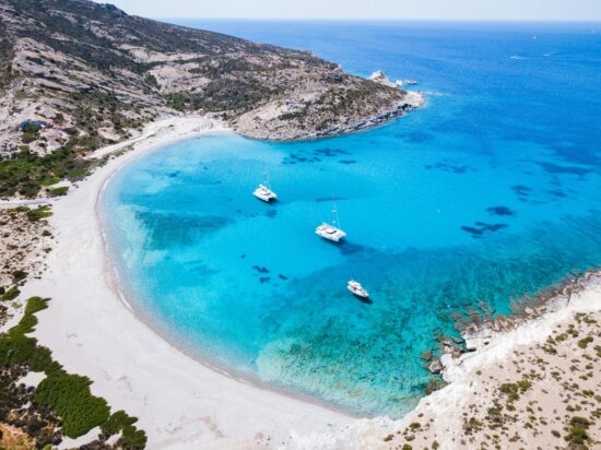 Turquois waters in a bay on the island Milos.